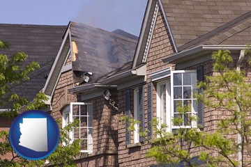 house fire damage with a smoldering roof - with Arizona icon