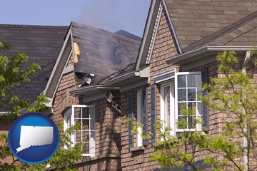 house fire damage with a smoldering roof - with Connecticut icon