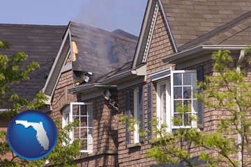 house fire damage with a smoldering roof - with Florida icon