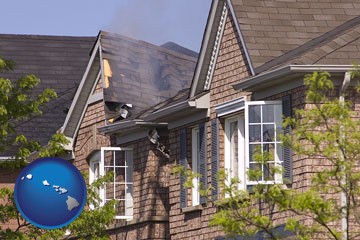 house fire damage with a smoldering roof - with Hawaii icon