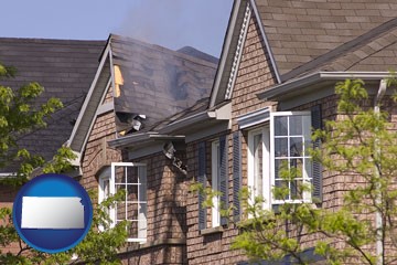 house fire damage with a smoldering roof - with Kansas icon