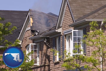 house fire damage with a smoldering roof - with Maryland icon