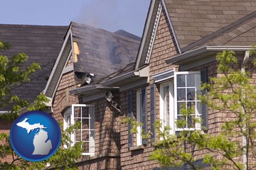 house fire damage with a smoldering roof - with Michigan icon