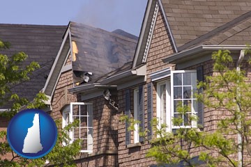 house fire damage with a smoldering roof - with New Hampshire icon