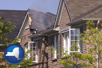 house fire damage with a smoldering roof - with New York icon