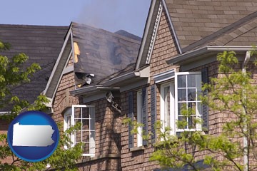 house fire damage with a smoldering roof - with Pennsylvania icon