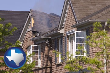 house fire damage with a smoldering roof - with Texas icon