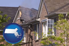 massachusetts map icon and house fire damage with a smoldering roof