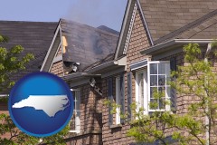 north-carolina map icon and house fire damage with a smoldering roof