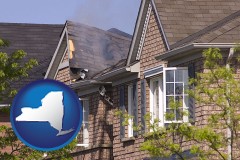 house fire damage with a smoldering roof - with NY icon