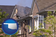 oklahoma map icon and house fire damage with a smoldering roof
