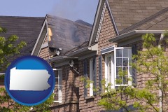 pennsylvania map icon and house fire damage with a smoldering roof